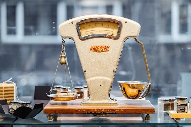 old fashion balancing scale sitting in a shop window
