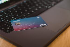 credit card laying on the keyboard of computer. Taking on debt is not one of the ways to pay for college