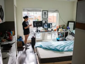College student in her college dorm which is very messy