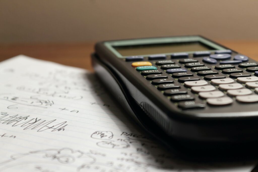 close up photo of a calculus calculator on a desk