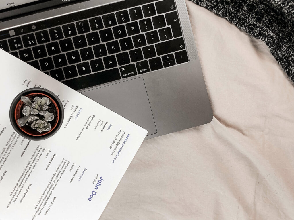 a close up pf a laptop and a CV vs resume