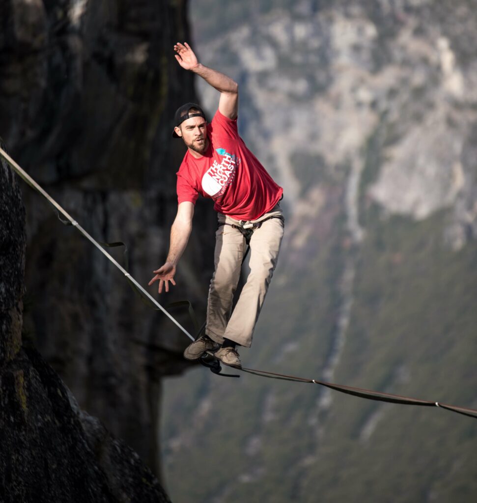 man walking a tightrope representing the balance of leadership skills